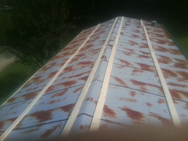 Rusted metal roof panels with new wood purlins before replacement — Storm Damage Roof Repair in Greenport by Roofing Brothers