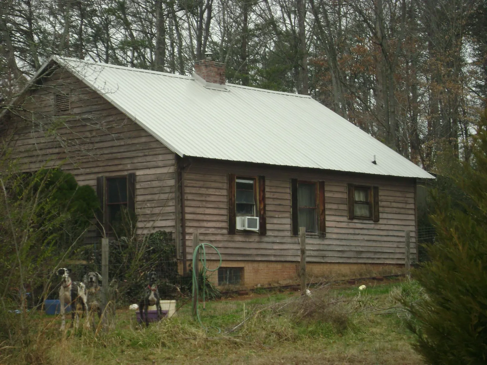 White metal roof on an old wood sided farmhouse, from a Metal Roof Installation job in Greenport